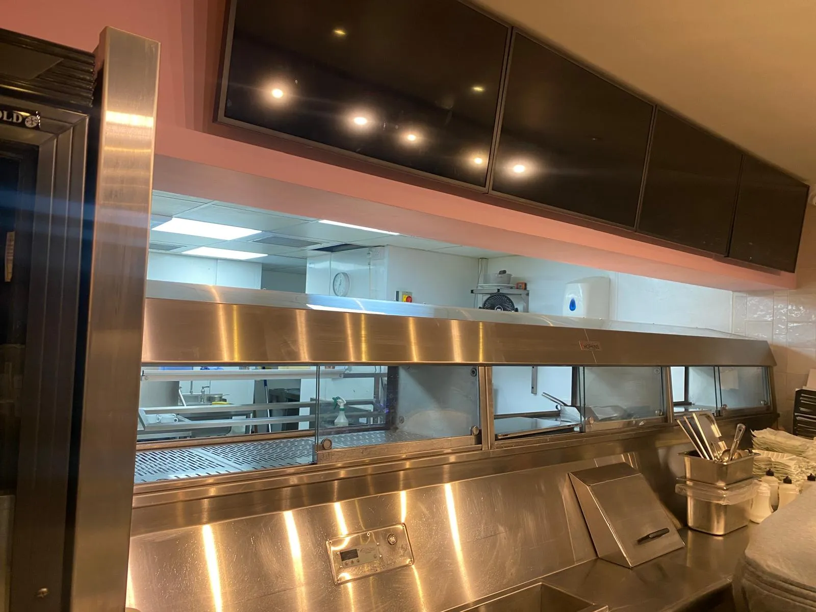 Cleaned stainless canopy above a commercial kitchen line