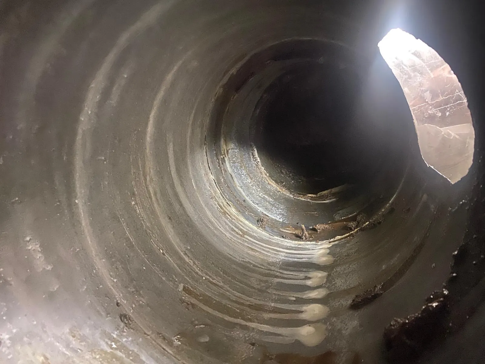 Spiral duct interior cleaned back to bare metal